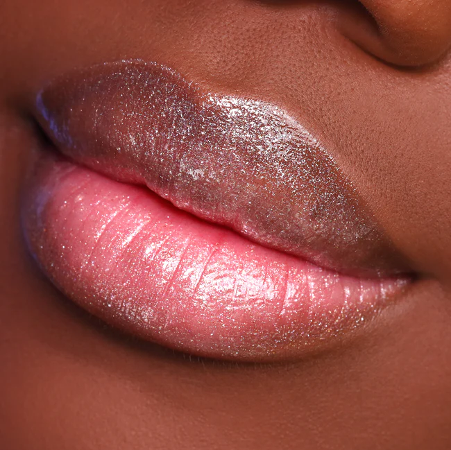 Clear gloss, gold glitter. Glossy Finish. Plant-Based. Vegan. Animal Cruelty-Free. Vitamin E Enriched - Moisturizing. Ultra-Lightweight - Non-Stick Formula. ella+mila Liquid Lipstick - Get The Glow